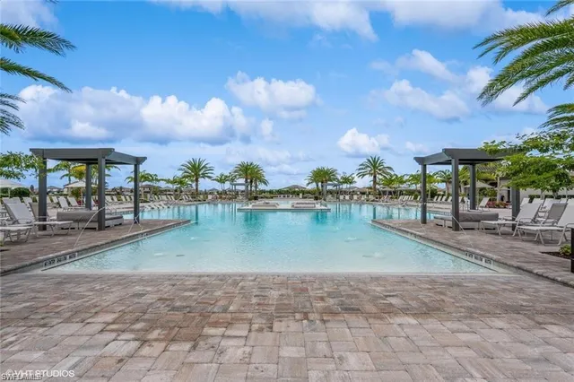 a view of a tennis ground with large trees