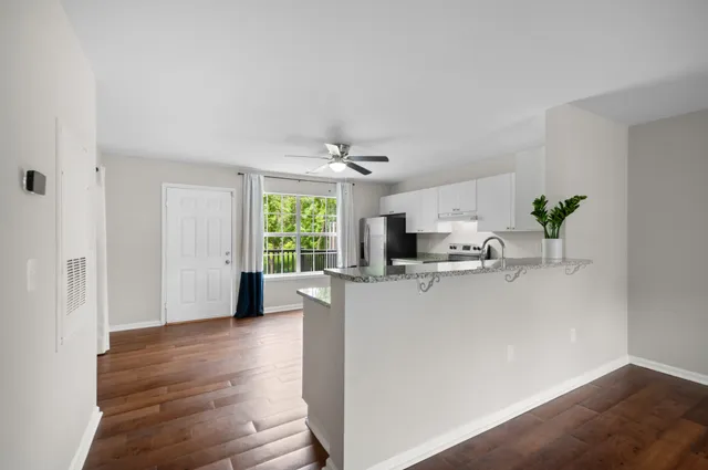 a view of kitchen with furniture and wooden floor