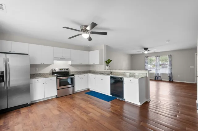 a kitchen with a refrigerator and a stove top oven
