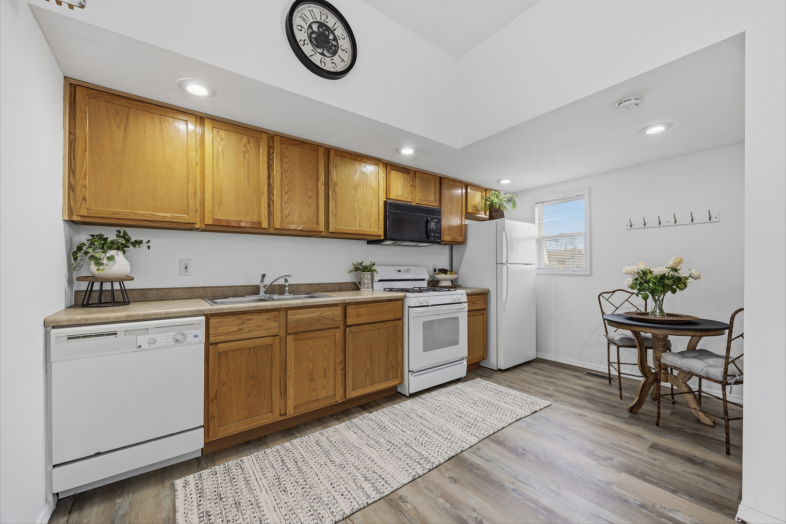 910 North Mason Street Bloomington, IL 61701 - Photo 10 of 29 a kitchen with sink cabinets and wooden floor