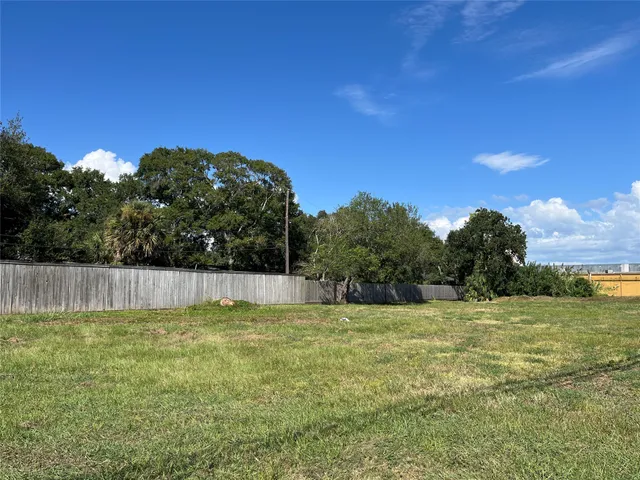 a view of a balcony with chair and wooden floor