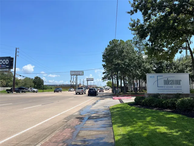 a street sign on a wall next to a road