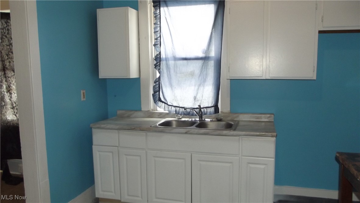 7805 Spafford Road Cleveland, OH 44105 - Photo 2 of 17 Bathroom featuring baseboards and a sink