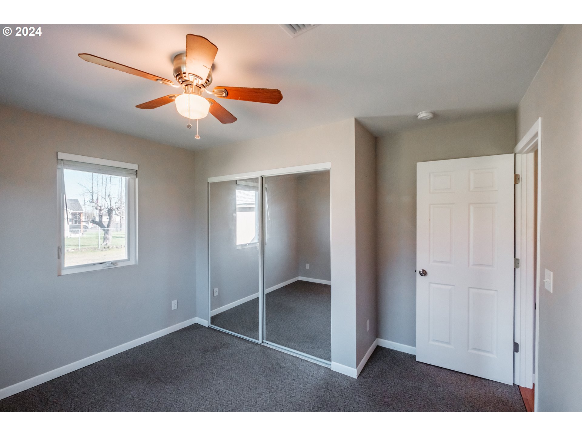 4715 Knox Butte Road East Albany, OR 97322 - Photo 17 of 30 a view of an empty room with window and chandelier fan
