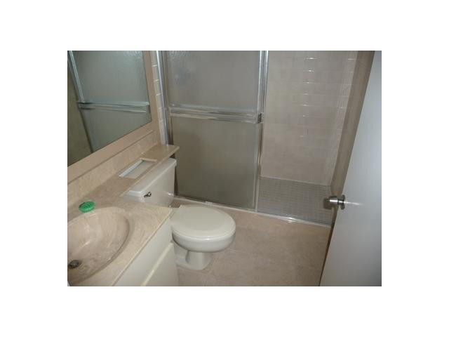 8134 Thames Boulevard, Unit D Boca Raton, FL 33433 - Photo 5 of 6 a bathroom with a sink toilet and shower