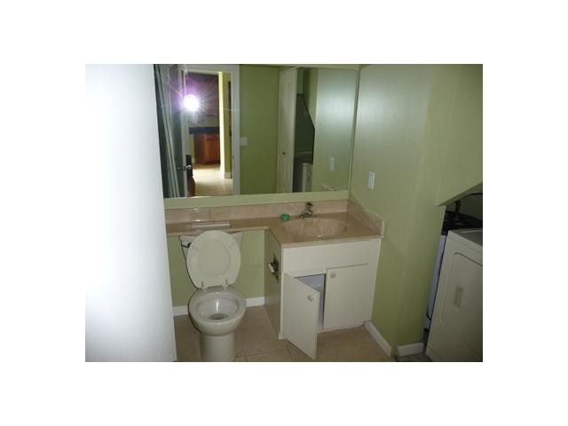 8134 Thames Boulevard, Unit D Boca Raton, FL 33433 - Photo 6 of 6 a bathroom with a sink and mirror