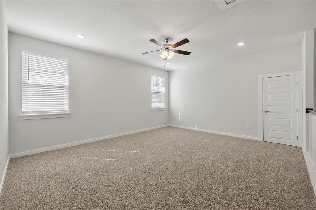 113 Shadow Oak Cove Georgetown, TX 78628 - Photo 26 of 40 A spacious secondary living area features carpeting, recessed lighting, and ample natural illumination from multiple windows.