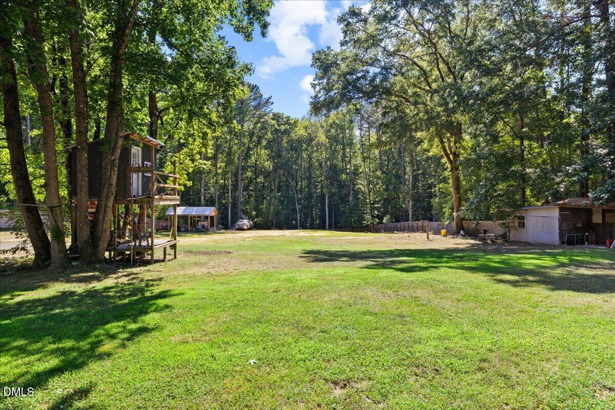 1304 Flying Hawk Road Apex, NC 27523 - Photo 40 of 52 a swimming pool with outdoor seating and yard