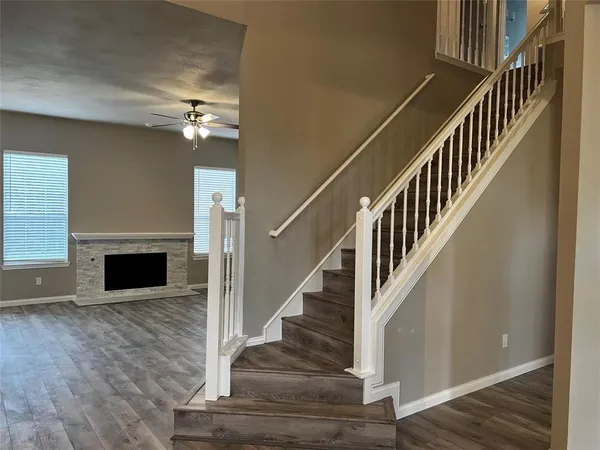a view of entryway and hall with wooden floor