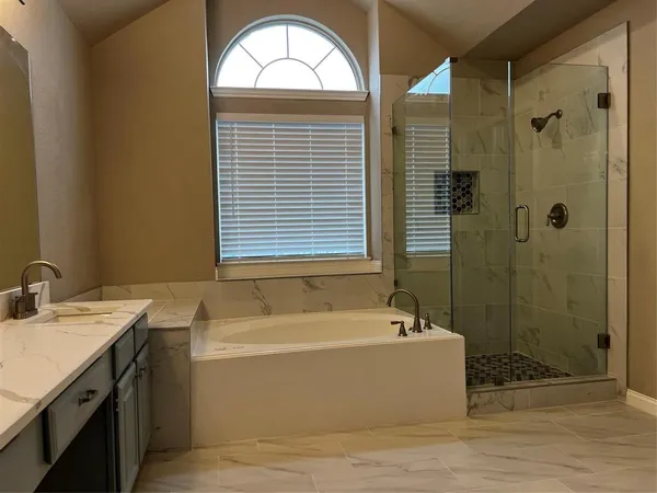 a bathroom with a bathtub and a sink