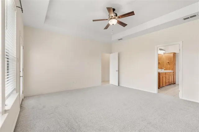 a bathroom with a white bath tub a mirror and a shower