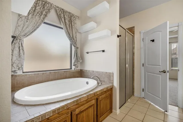 an empty room with windows and ceiling fan