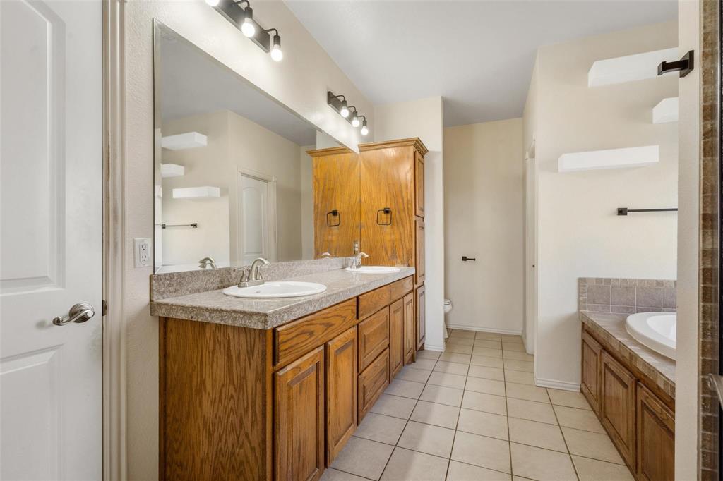 2833 Willow Ridge Circle Granbury, TX 76049 - Photo 21 of 23 a bathroom with a sink a toilet and shower
