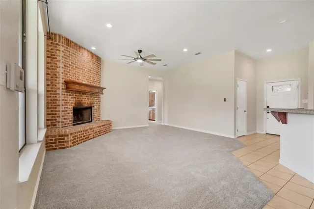 a view of an empty room with a fireplace