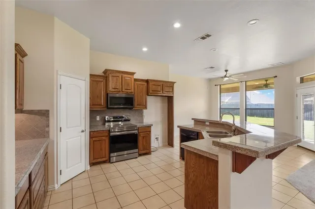 a kitchen with a stove and a refrigerator