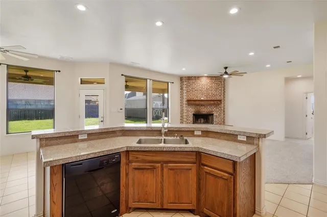 a kitchen with granite countertop a sink and a stove top oven