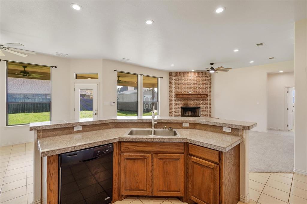 2833 Willow Ridge Circle Granbury, TX 76049 - Photo 8 of 23 a kitchen with granite countertop a sink and a stove top oven