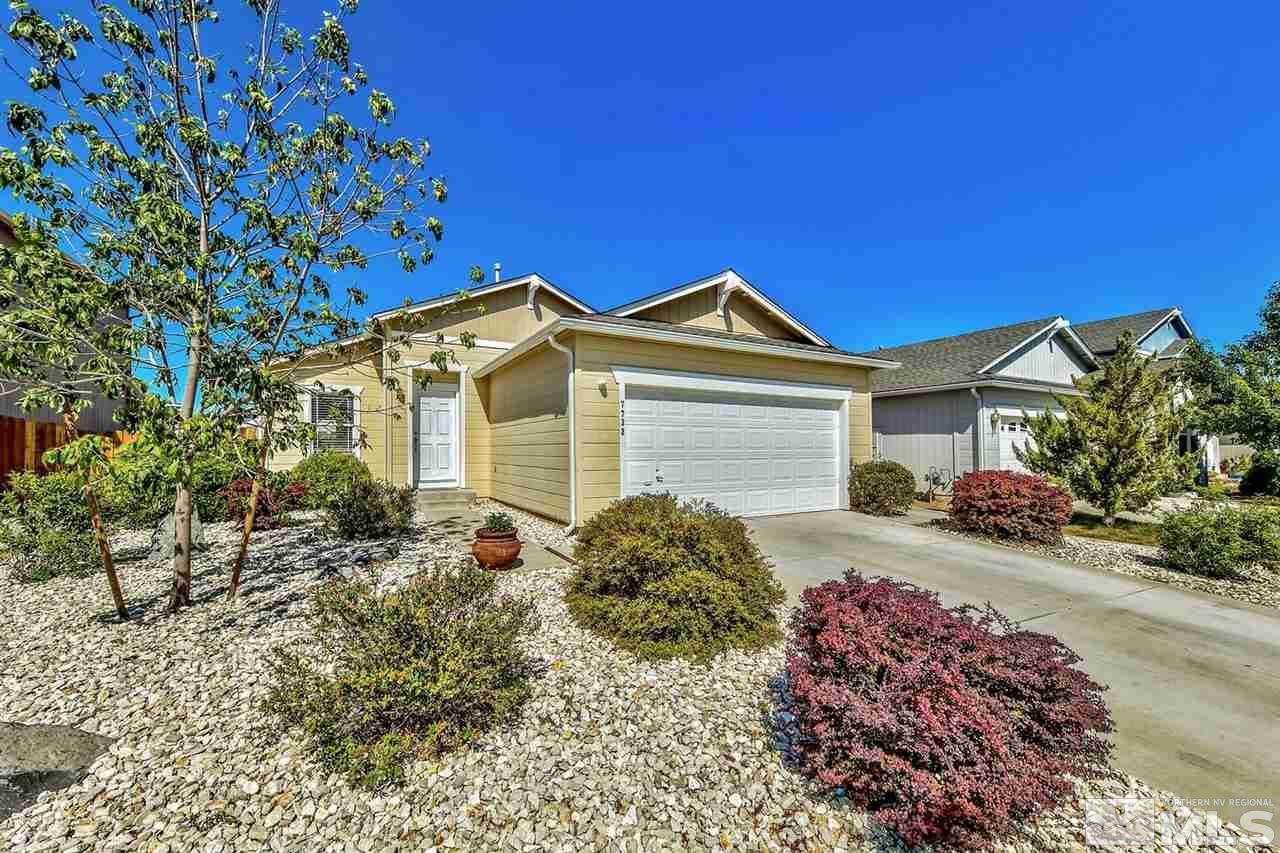 7733 Tulear Street Reno, NV 89506 - Photo 1 of 16 a front view of a house with a garden