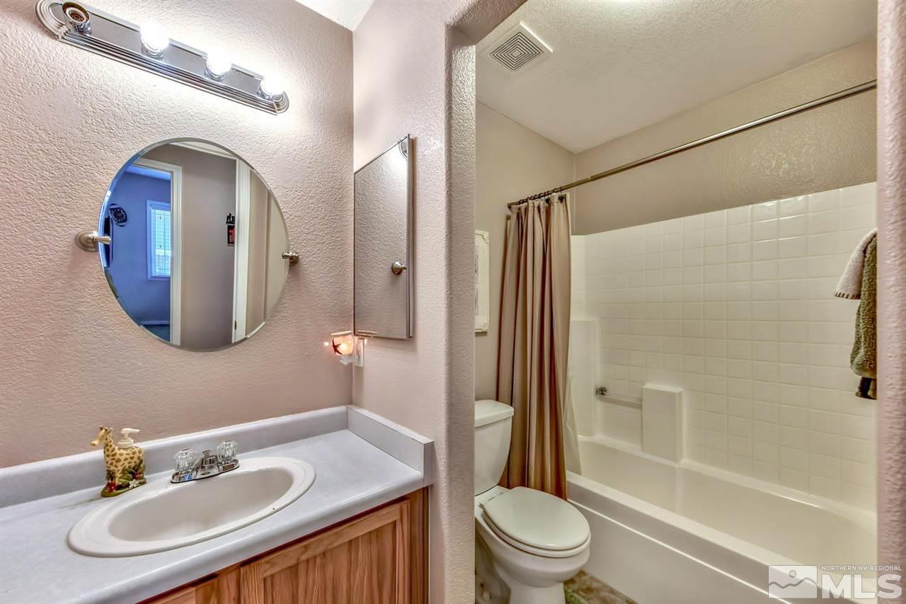 7733 Tulear Street Reno, NV 89506 - Photo 13 of 16 a bathroom with a sink toilet and shower