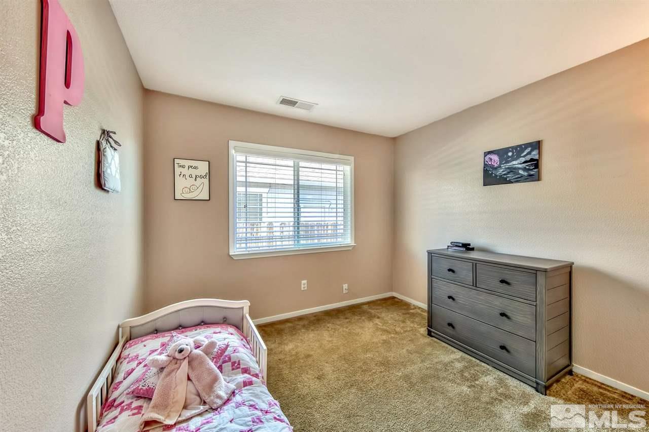 7733 Tulear Street Reno, NV 89506 - Photo 14 of 16 a bedroom with a bed and a dresser in it