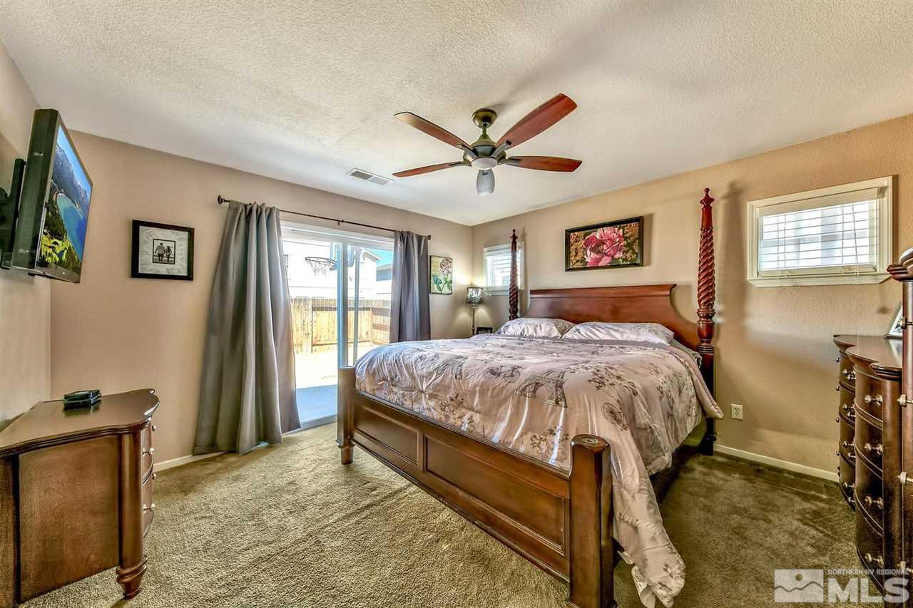 7733 Tulear Street Reno, NV 89506 - Photo 10 of 16 a bed sitting in a spacious bedroom next to a window