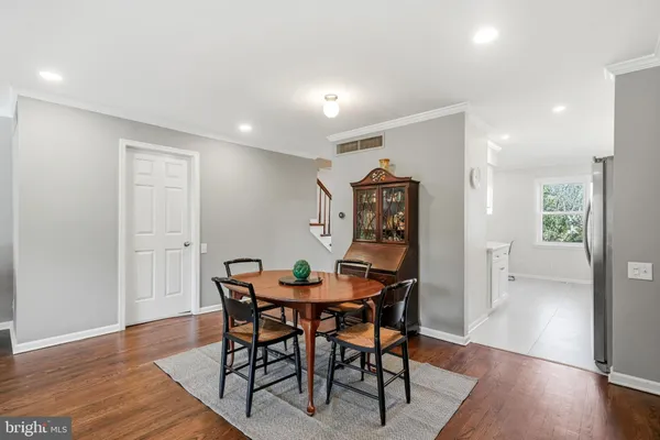 a living room with furniture and a flat screen tv with wooden floor