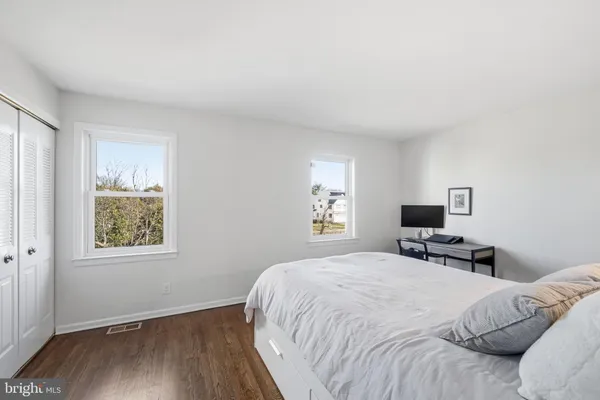 a bedroom with a large bed and a window