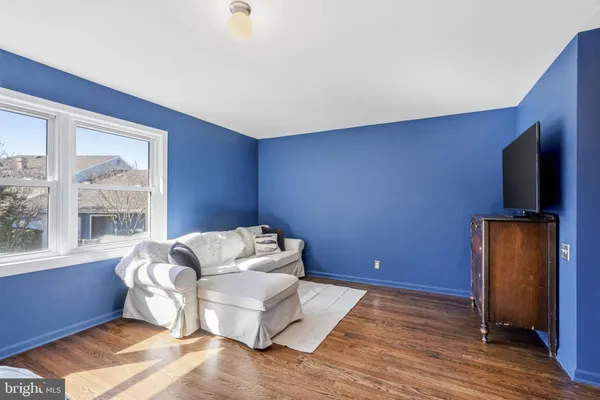 a bedroom with a bed window and a couch