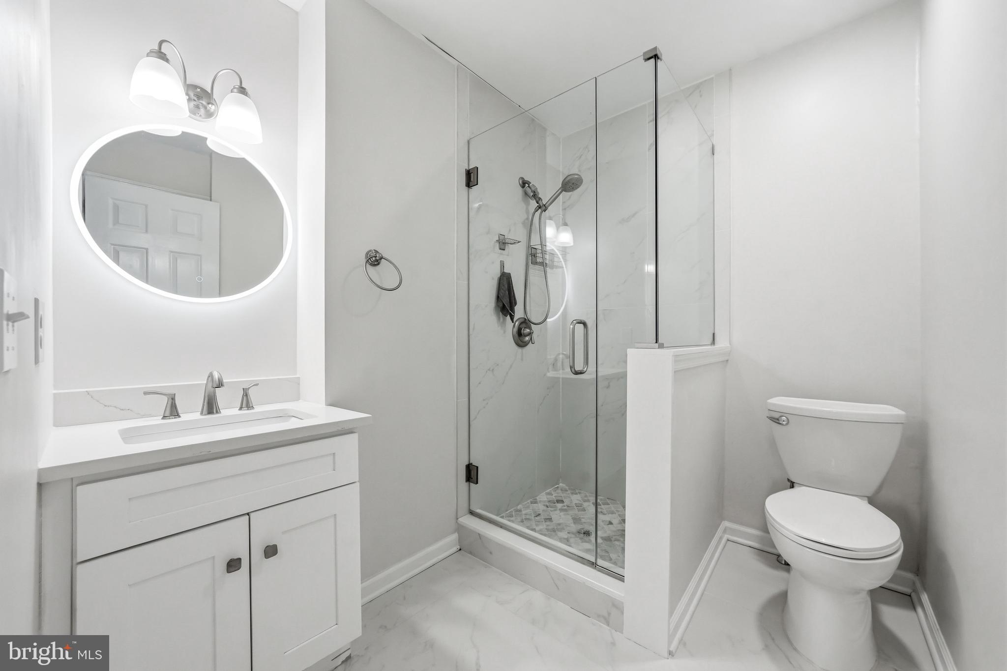 635 East Main Street, Unit 7 Moorestown, NJ 08057 - Photo 35 of 52 a bathroom with a toilet a sink a mirror and vanity