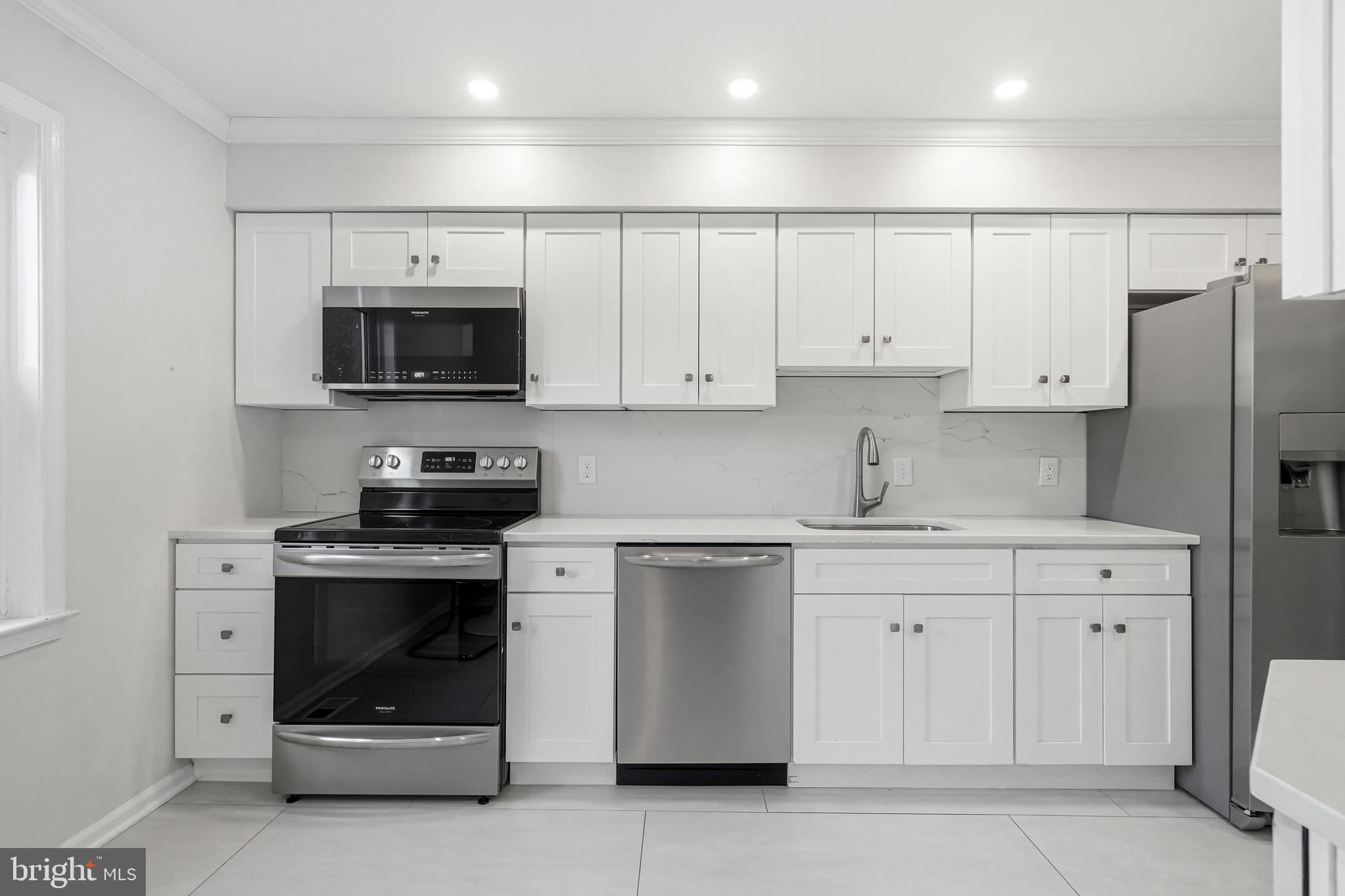 635 East Main Street, Unit 7 Moorestown, NJ 08057 - Photo 9 of 52 a kitchen with white cabinets and stainless steel appliances