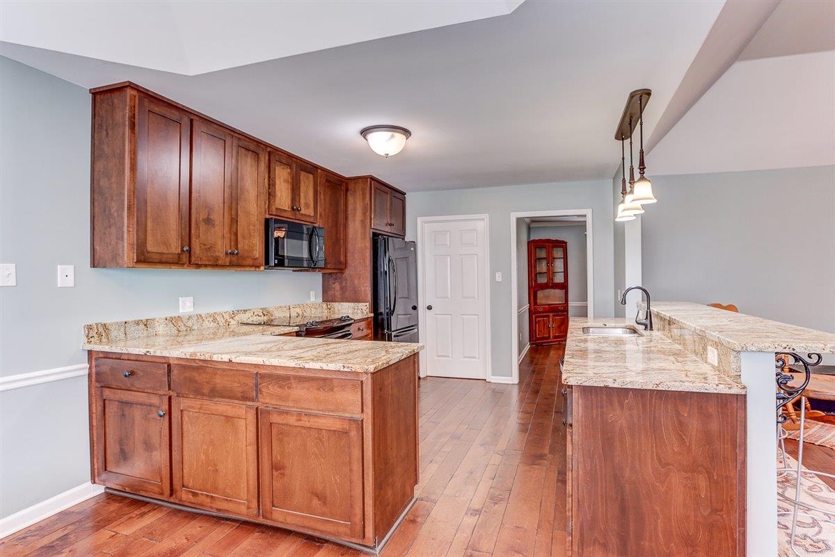 665 Lancelot Lane Collierville, TN 38017 - Photo 11 of 26 a kitchen with a wooden floor window and cabinets