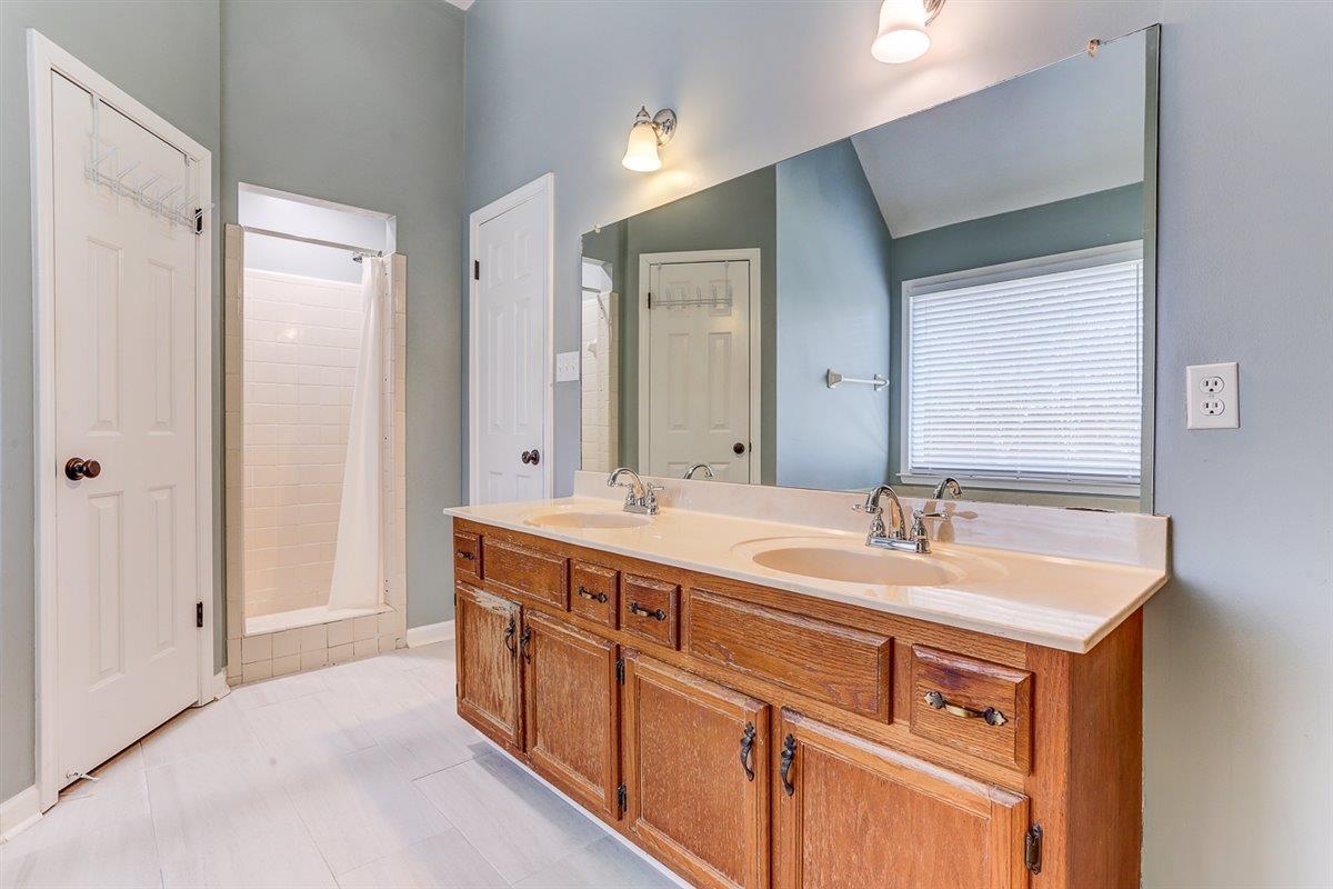 665 Lancelot Lane Collierville, TN 38017 - Photo 17 of 26 a bathroom with a double vanity sink and mirror