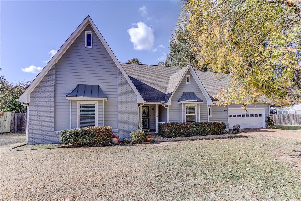 665 Lancelot Lane Collierville, TN 38017 - Photo 2 of 26 a front view of a house with a yard and garage