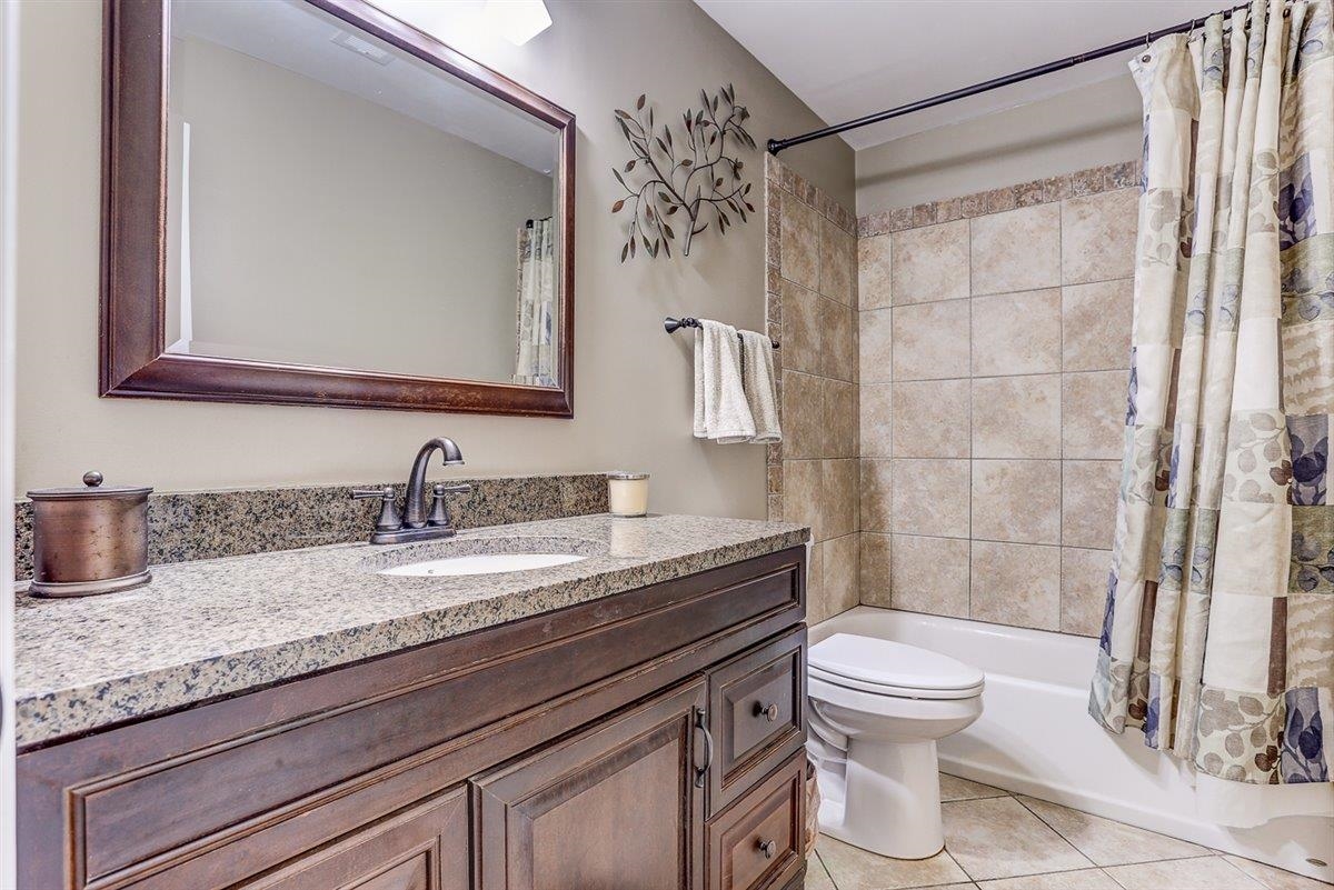 665 Lancelot Lane Collierville, TN 38017 - Photo 21 of 26 a bathroom with a granite countertop sink toilet mirror and shower
