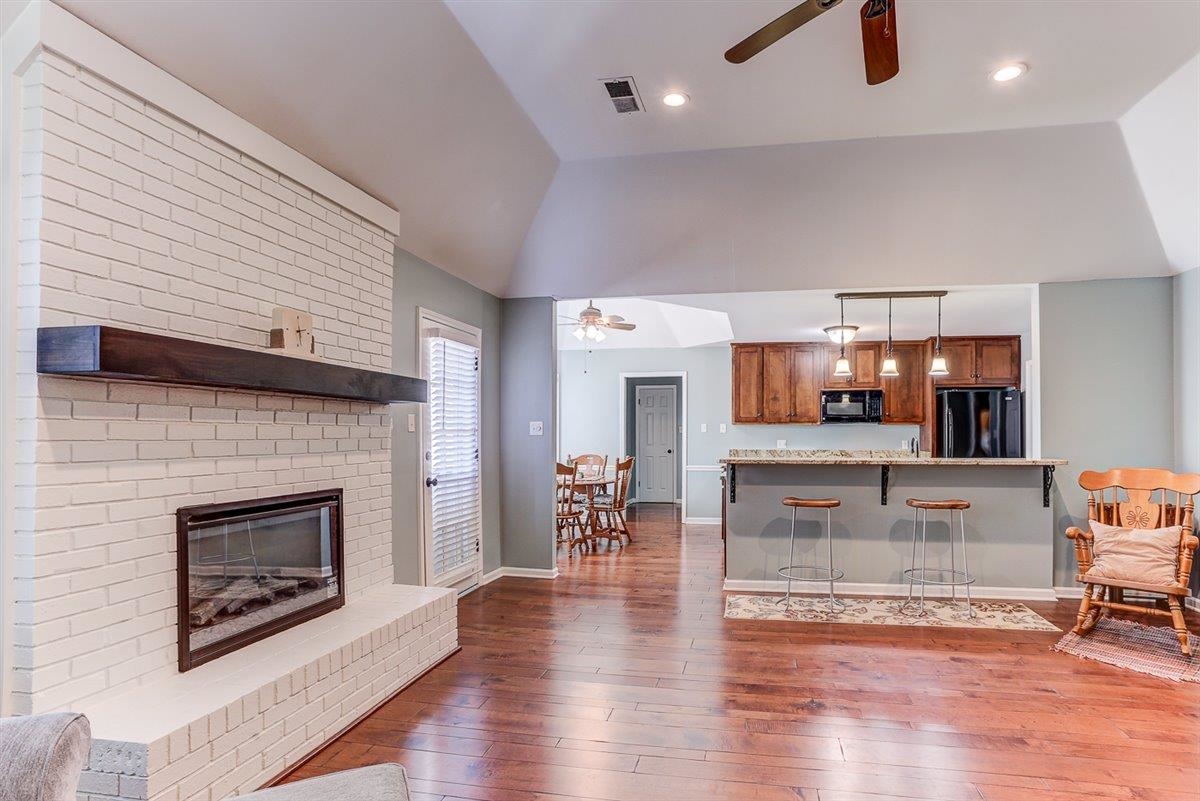 665 Lancelot Lane Collierville, TN 38017 - Photo 8 of 26 a living room with furniture wooden floor and a fireplace