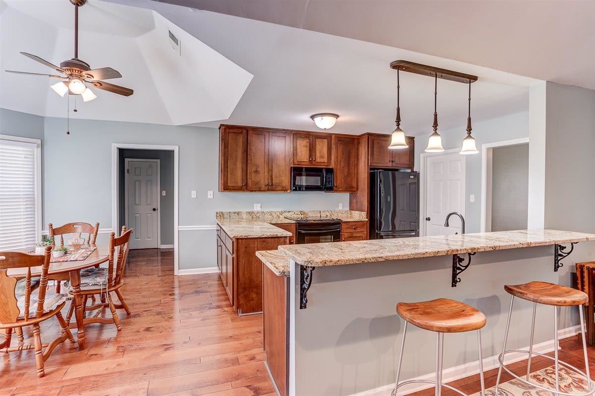 665 Lancelot Lane Collierville, TN 38017 - Photo 10 of 26 a living room with granite countertop kitchen furniture and a wooden floor