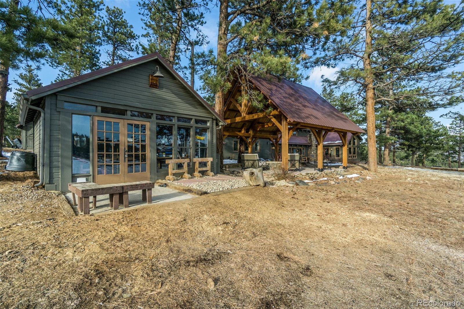 11711 Rist Canyon Road Bellvue, CO 80512 - Photo 29 of 39 a house with trees in the background