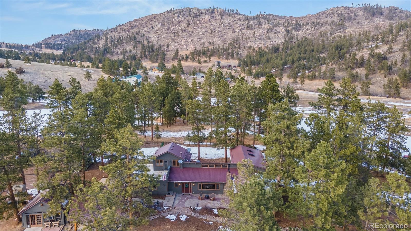 11711 Rist Canyon Road Bellvue, CO 80512 - Photo 3 of 39 an aerial view of a house with a yard and mountain