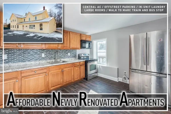 a kitchen with kitchen island and stainless steel appliances