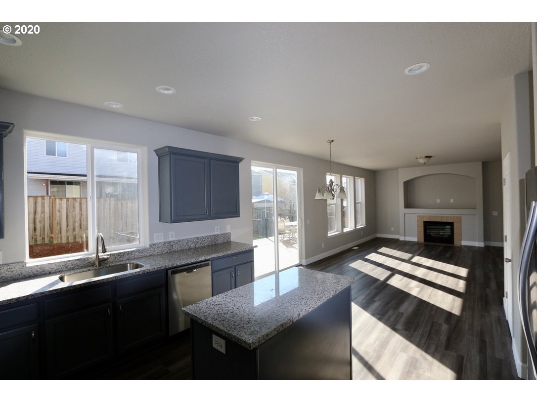1986 Southwest 33rd Street Gresham, OR 97080 - Photo 15 of 32 a kitchen with granite countertop a stove a sink and a refrigerator