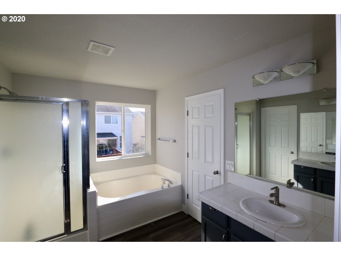 1986 Southwest 33rd Street Gresham, OR 97080 - Photo 23 of 32 a bathroom with a sink vanity granite tub shower and a mirror