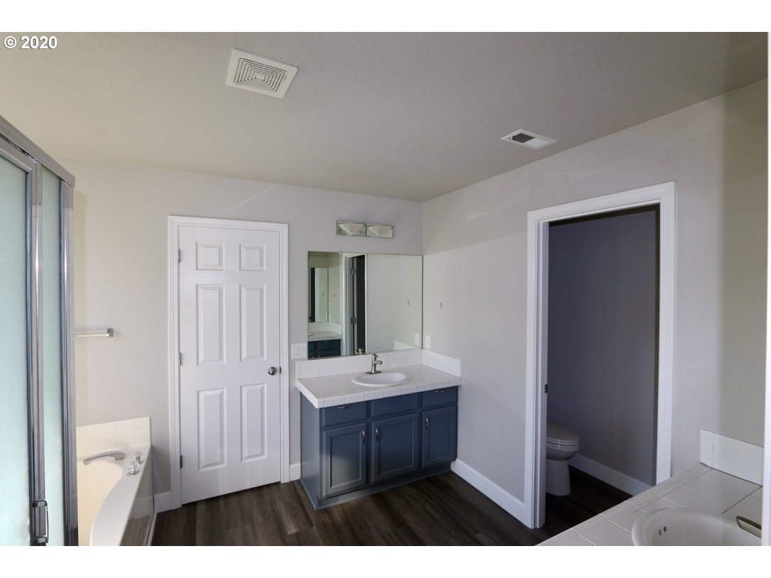 1986 Southwest 33rd Street Gresham, OR 97080 - Photo 24 of 32 a bathroom with a sink a mirror and a toilet