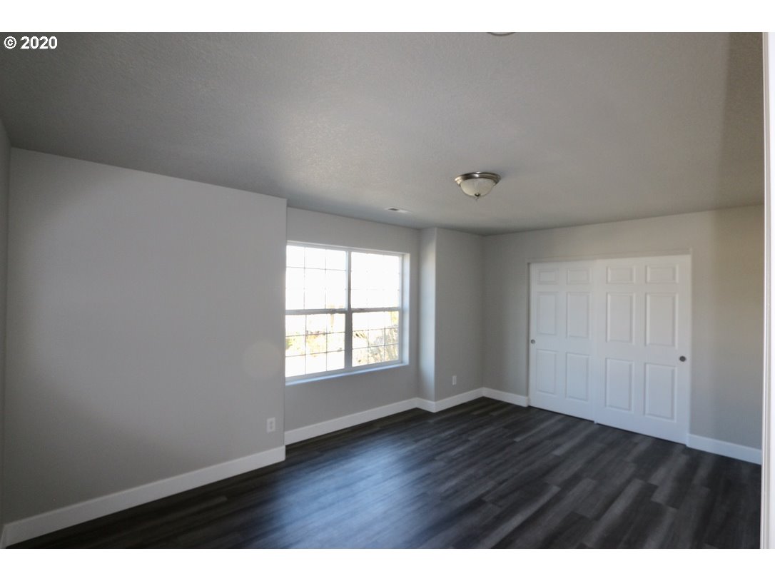 1986 Southwest 33rd Street Gresham, OR 97080 - Photo 28 of 32 a view of an empty room with wooden floor and a window