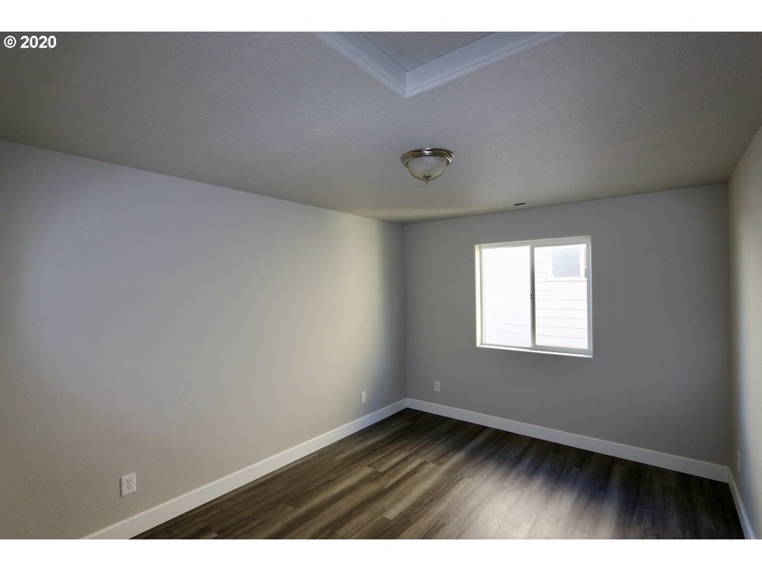 1986 Southwest 33rd Street Gresham, OR 97080 - Photo 29 of 32 a view of an empty room with wooden floor and a window