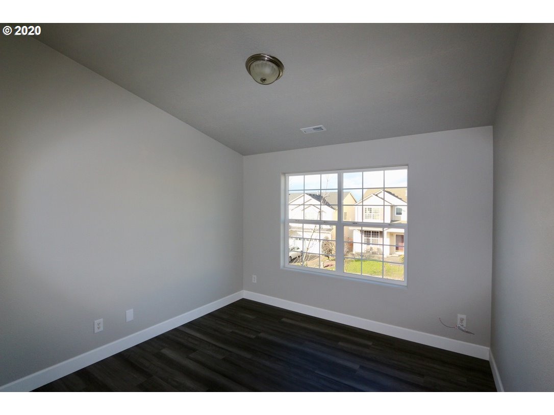 1986 Southwest 33rd Street Gresham, OR 97080 - Photo 31 of 32 a view of an empty room with wooden floor and a window