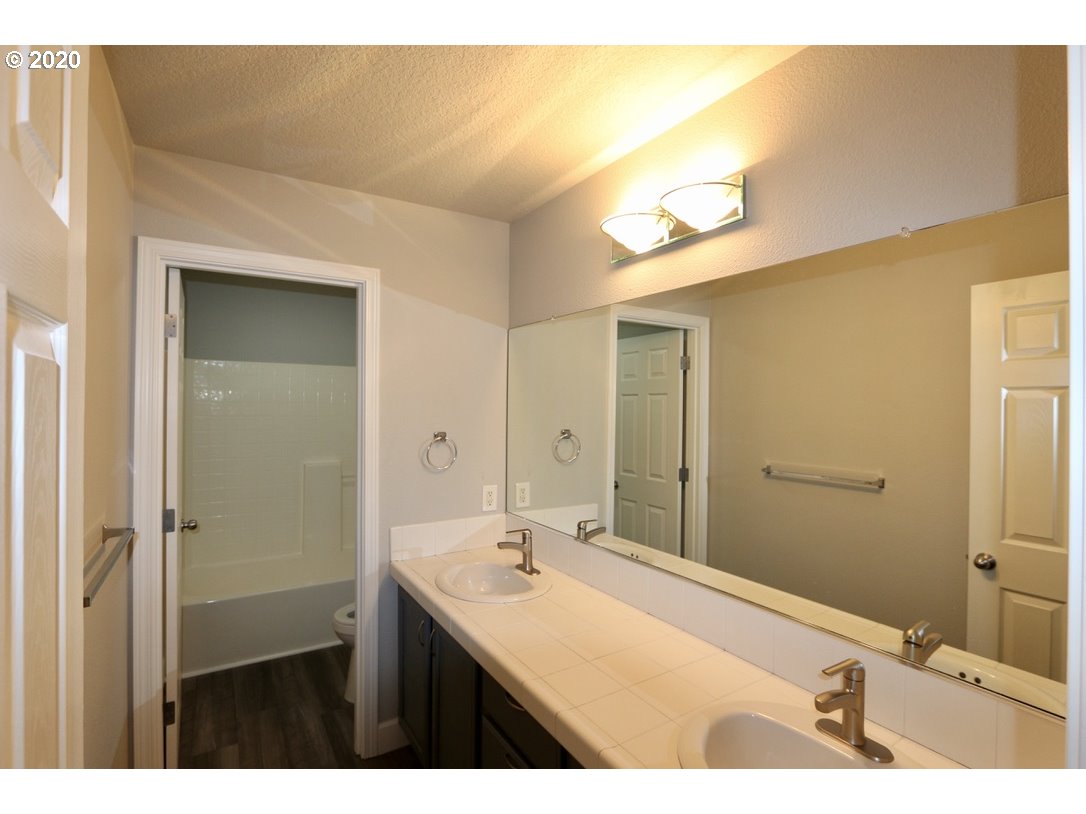 1986 Southwest 33rd Street Gresham, OR 97080 - Photo 32 of 32 a bathroom with a sink and a mirror