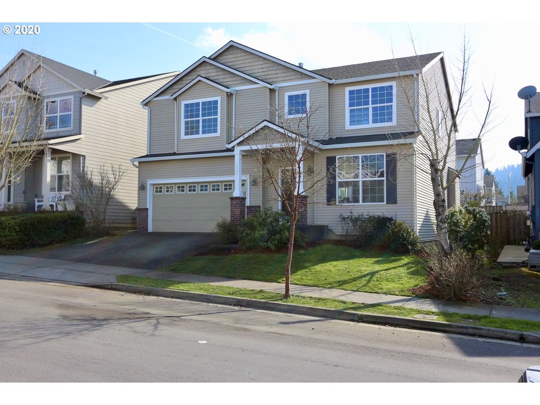 1986 Southwest 33rd Street Gresham, OR 97080 - Photo 4 of 32 a front view of a house with a yard and garage