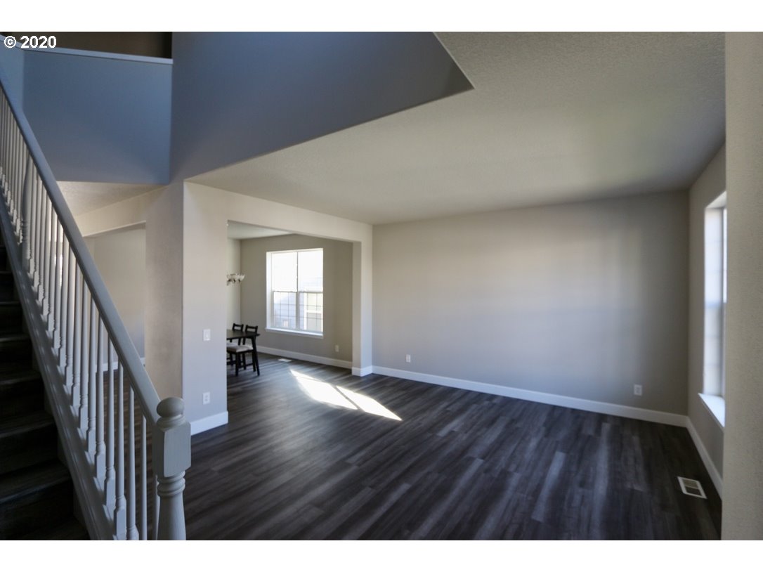 1986 Southwest 33rd Street Gresham, OR 97080 - Photo 8 of 32 a view of an empty room with wooden floor and a window