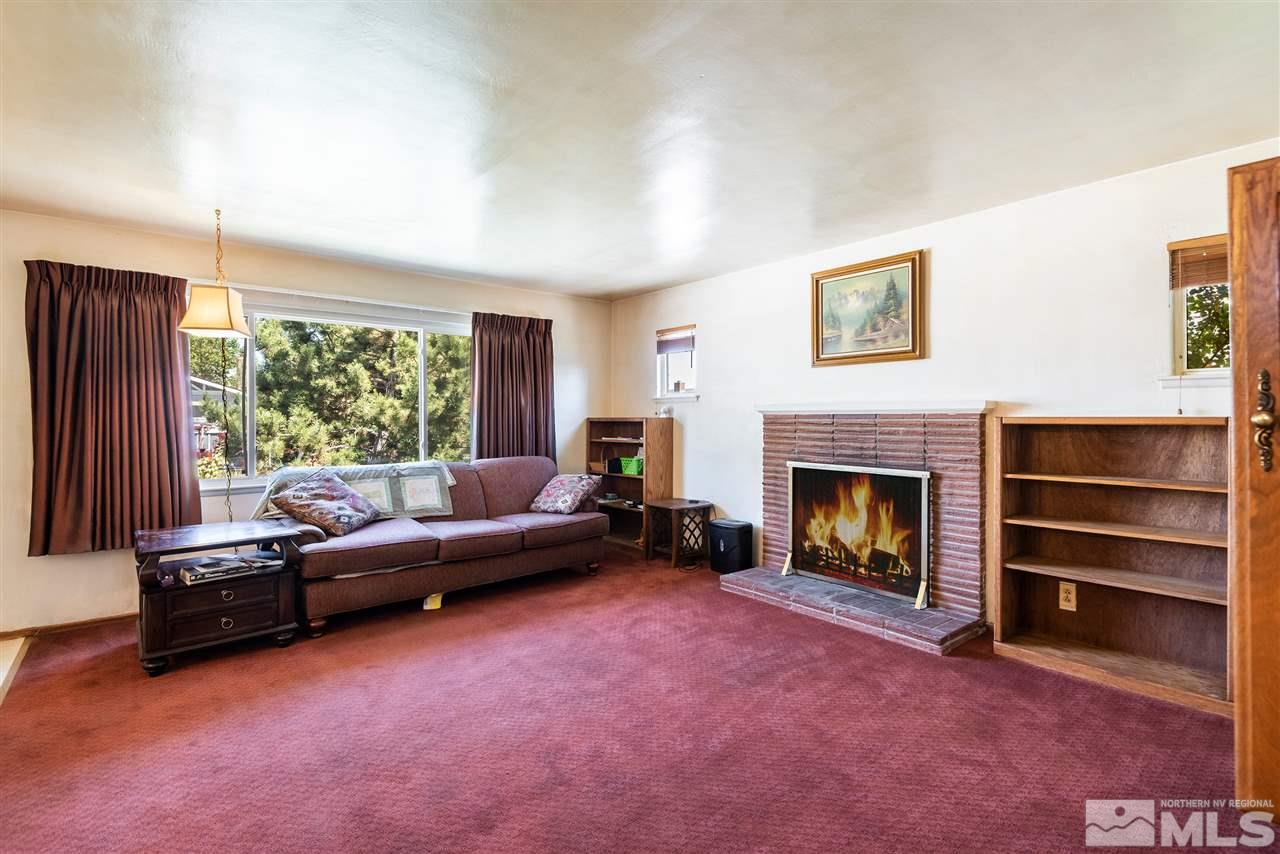 1555 Auburn Way Reno, NV 89502 - Photo 3 of 14 a living room with furniture and a fireplace