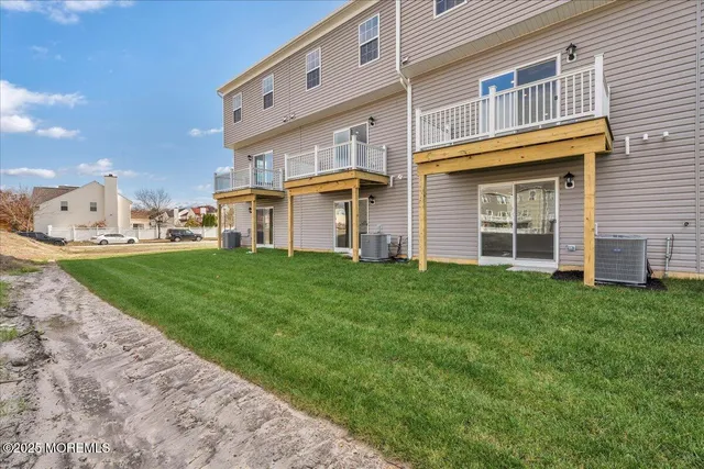 a view of a white house with a yard and table and chair